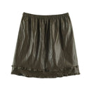 An olive green crinkled faux-leather mini skirt with an elastic waistband and a double ruffle hem, shown flat on a white background, Obroi