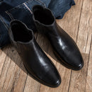 Pair of black leather boots on a wooden floor with blue jeans ,Obroi