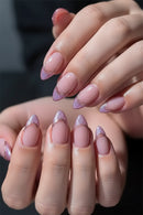 Close-up of hands with pink and purple glittery nail polish on a dark background, Obroi