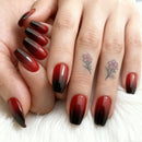 Close-up of hands with red and black gradient nail polish on a white background, Obroi