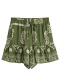 Green shorts with white floral patterns on a white background, Obroi