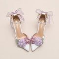 White high-heeled shoes with floral decorations and ribbons on a beige background, Obroi