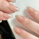 Close-up of hands with glittery nail polish on a neutral background, Obroi