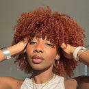 Woman with red curly hair wearing a white top against a neutral background, Obroi
