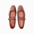 Pair of brown flat shoes with a strap on a white background, Obroi