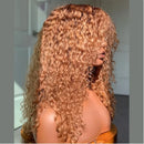 Long, voluminous curly wig with a warm honey-blonde to light brown ombre color, shown on a mannequin head against a softly blurred indoor background, Obroi
