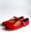 Red leather shoes with brown soles on a white background, Obroi