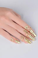 Gold nail art with decorative designs on a white background, Obroi