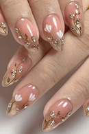 Nails with pink and gold floral design on a neutral background, Obroi