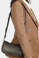 Person wearing a brown coat with a black handbag on a white background, Obroi