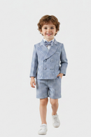 Young boy wearing a blue checkered suit with a bow tie on a white background, Obroi