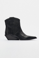 Black leather cowboy boot on a white background, Obroi