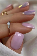 Close-up of a hand with pink nail polish and a gold ring on a light background, Obroi