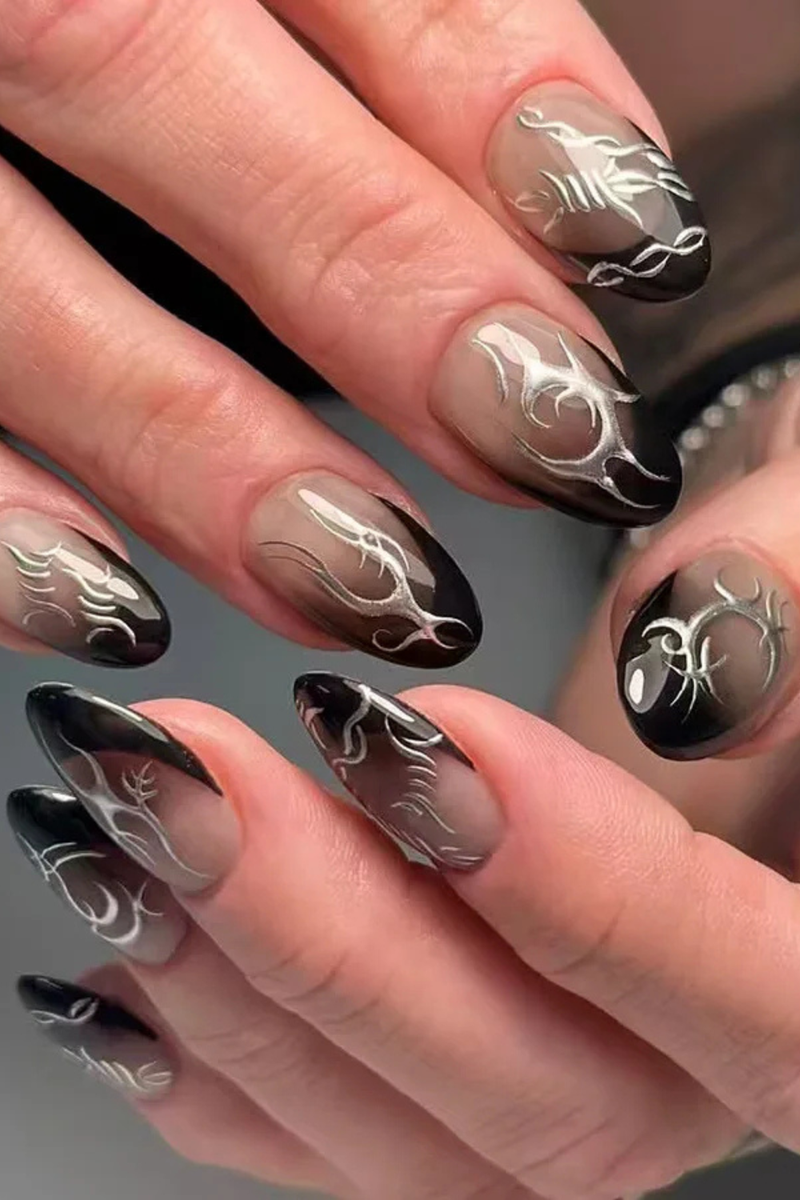 Nails with black and silver decorative design on a neutral background, Obroi