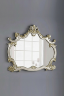 Decorative wall mirror with an ornate frame on a gray wall, Obroi