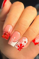 Close-up of a hand with red and white floral nail art, Obroi