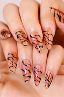 Nails with tiger stripe design on a neutral background, Obroi