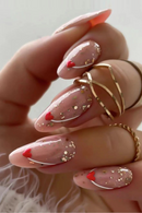 Nail art with red tips and gold glitter on a neutral background, Obroi