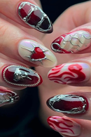 Nail art with red, white, and silver designs on a dark background, Obroi