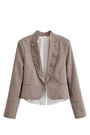 A cropped, double-breasted blazer in a textured taupe-brown fabric, featuring decorative gold-tone buttons and a white shirt underneath, displayed on a clean white background, Obroi