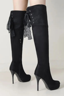 Black knee-high boots with high heels on a light background, Obroi