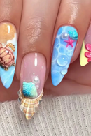 Nails with ocean-themed decorations including shells, starfish, and bubbles on a neutral background, Obroi