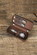 Open brown leather case with a watch and tools on a wooden surface, Obroi