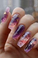 Nails with a gradient design of pink, purple, and gold on a blurred background, Obroi