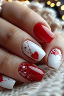 Nails with red and white design, featuring hearts, on a textured surface, Obroi