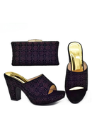 Purple high-heeled shoes with matching clutch on a white background, Obroi