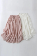 Two pairs of flowing pants, one pink and one white, on a light gray background, Obroi