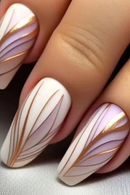 Nails with white and gold decorative patterns on a neutral background, Obroi