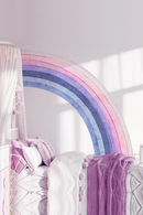 Decorative rainbow arch in a room with soft lighting, Obroi