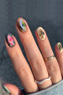 Nails with fish designs on a dark background, Obroi