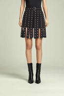 Black patterned skirt worn by a person on a light gray background, Obroi