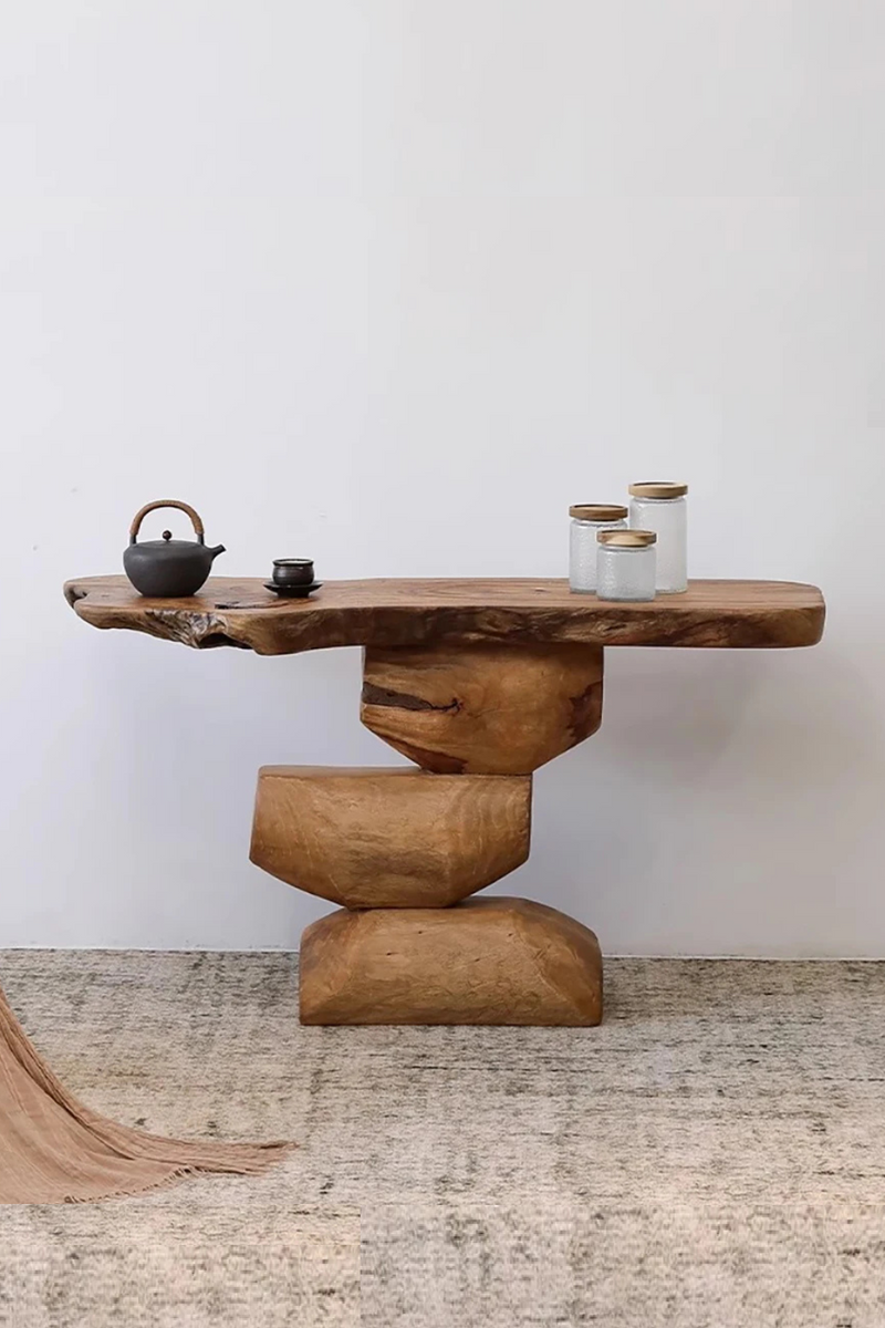 Wooden console table with decorative items against a white wall, Obroi