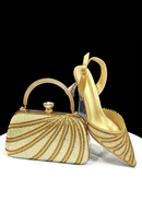 Gold clutch bag and high-heeled shoe on a white background, Obroi