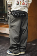 Person wearing a graphic t-shirt and dark pants with a blurred background, Obroi