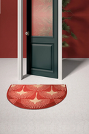 Red patterned doormat in front of a green door with a red wall background, Obroi