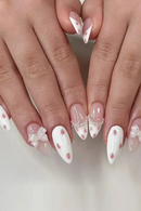 Close-up of hands with decorative nail art on a neutral background, Obroi