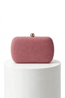 Pink clutch bag with a gold clasp on a white pedestal against a white background, Obroi