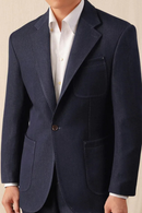 Navy blazer worn by a person on a beige background, Obroi