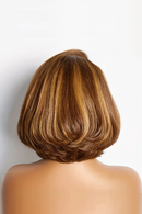 Back view of a person with a styled haircut on a plain background, Obroi