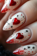 Nails with red heart and star designs on a white background, Obroi