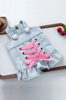 Denim dog dress with pink laces on a white surface, Obroi