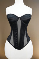 Black corset on a mannequin against a gradient background, Obroi