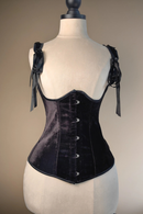Black velvet corset on a mannequin against a neutral background, Obroi