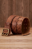 Brown leather belt with brass buckle on a wooden surface, Obroi
