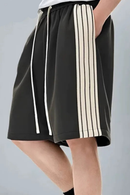 Black skirt with white stripes on a gray background, Obroi
