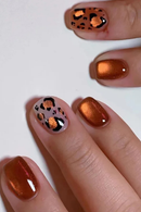 Nails with bronze and leopard print design on a white background, Obroi